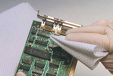 microelectronics device being wiped with a cloth