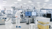 Interior view of a pharmaceutical cleanroom with modern equipment and stringent cleanliness protocols