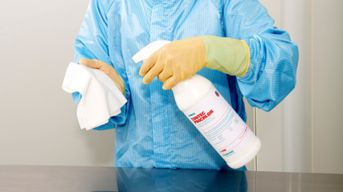 A person spraying ProChlor onto a wipe, demonstrating the application process